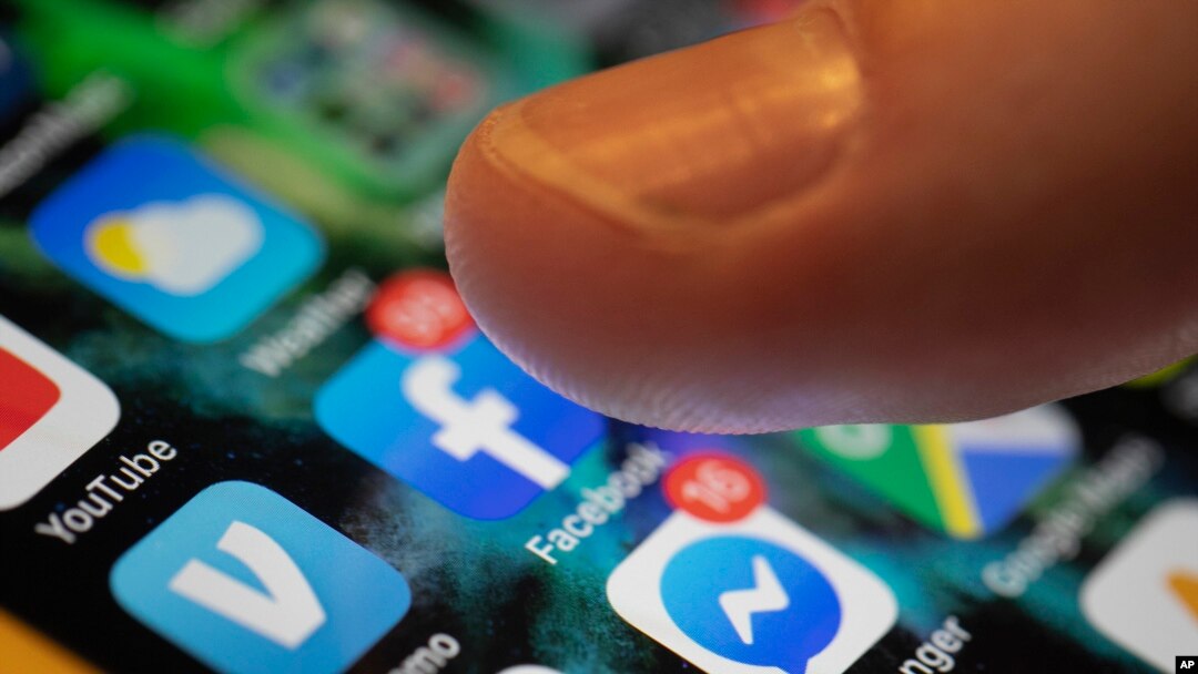 In this Aug. 11, 2019, photo an iPhone displays the apps for Facebook and Messenger in New Orleans. 