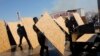 Protesters take cover as riot police use water cannons and tear gas to disperse them in Silivri, where a hearing on people charged with attempting to overthrow Prime Minister Tayyip Erdogan's Islamist-rooted government is due to take place, August 5, 201