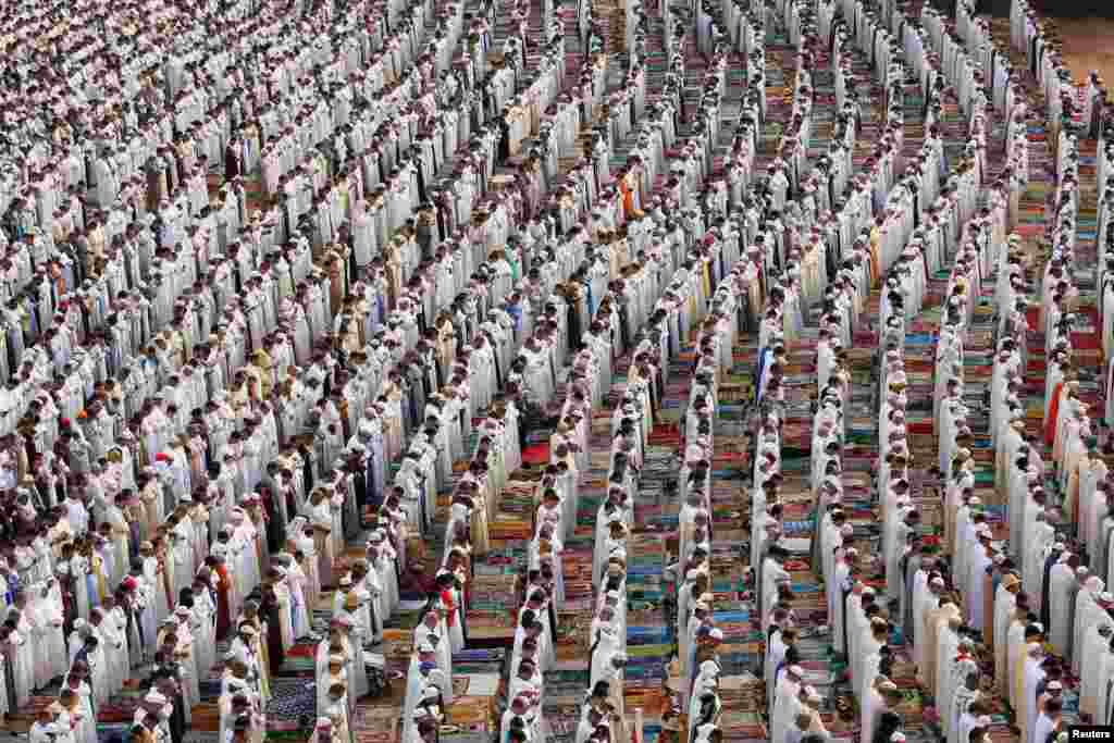 People attend Eid al-Fitr prayers to mark the end of the holy fasting month of Ramadan at a play ground in the suburb of Sale, Morocco.
