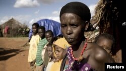 Karsi Tadicha and her children stand next to their house in Bule Duba village, on the outskirts of Moyale, Ethiopia, June 2009.