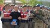 Akin Ozturk, a former Turkish Air Force commander who is accused of plotting and orchestrating last year's failed coup, is escorted by gendarmes as he arrives at the court in Ankara, Turkey, May 22, 2017. 