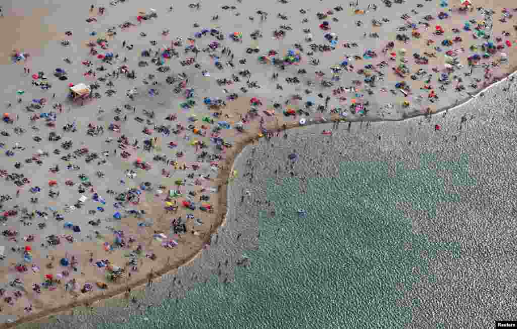 An aerial view shows people at a beach on the shores of lake Silbersee (Silver Lake) during a long-lasting heatwave over central Europe in Haltern, Germany, Aug. 4, 2018.