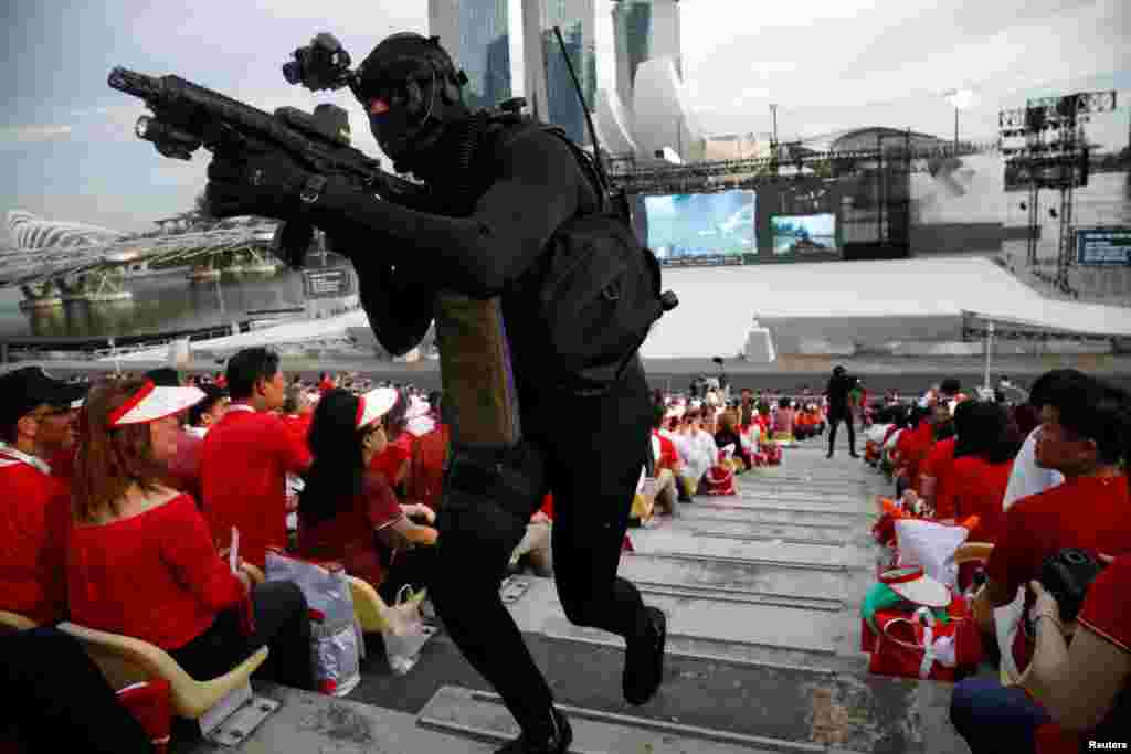 A navy diver storms into the gallery during a military display at Singapore's 52nd National Day celebrations at Marina Bay in Singapore.