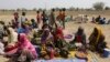 FILE - People displaced by Boko Haram wait to be screened at Furore camp in Yola, Nigeria, near the country's border with Cameroon, Dec. 8, 2015. Returnees to Cameroon have have been rejected by their communities. 
