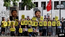FILE - Activists of Amnesty International stage a protest against the detention of the head of Amnesty International in Turkey, Taner Kilic, in front of the Turkish Embassy in Berlin on June 15, 2017.