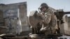 FILE - A soldier gives a thumbs-up sign as Turkish army's armored vehicles and tanks roll into the Syrian town of Ayn al-Arab, Feb. 22, 2015.