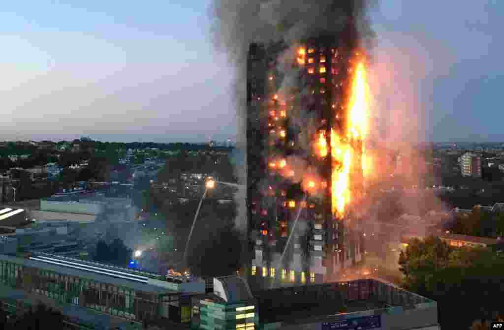 Flames and smoke coming from a 27-story apartment tower are seen after a fire broke out in west London. The fire brigade said 40 fire engines and 200 firefighters had been called to the blaze in Grenfell Tower, which has 120 apartments.