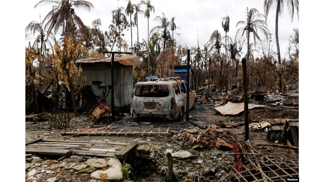 FILE - A car is seen near a house that was burnt down during the last days violence in Maungdaw, Myanmar Aug. 31, 2017.