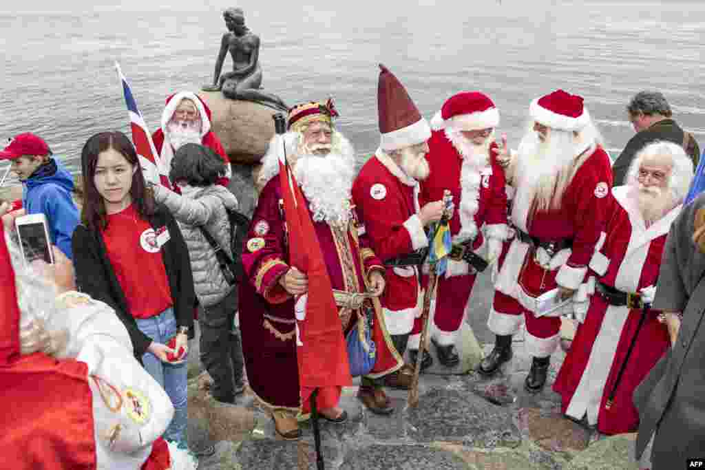 Participants of the Santa Claus World Congress visit the Little Mermaid statue in Copenhagen, Denmark.