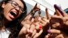 Tunisians show their ink-stained fingers after casting their votes in Tunis, Oct. 26, 2014. 