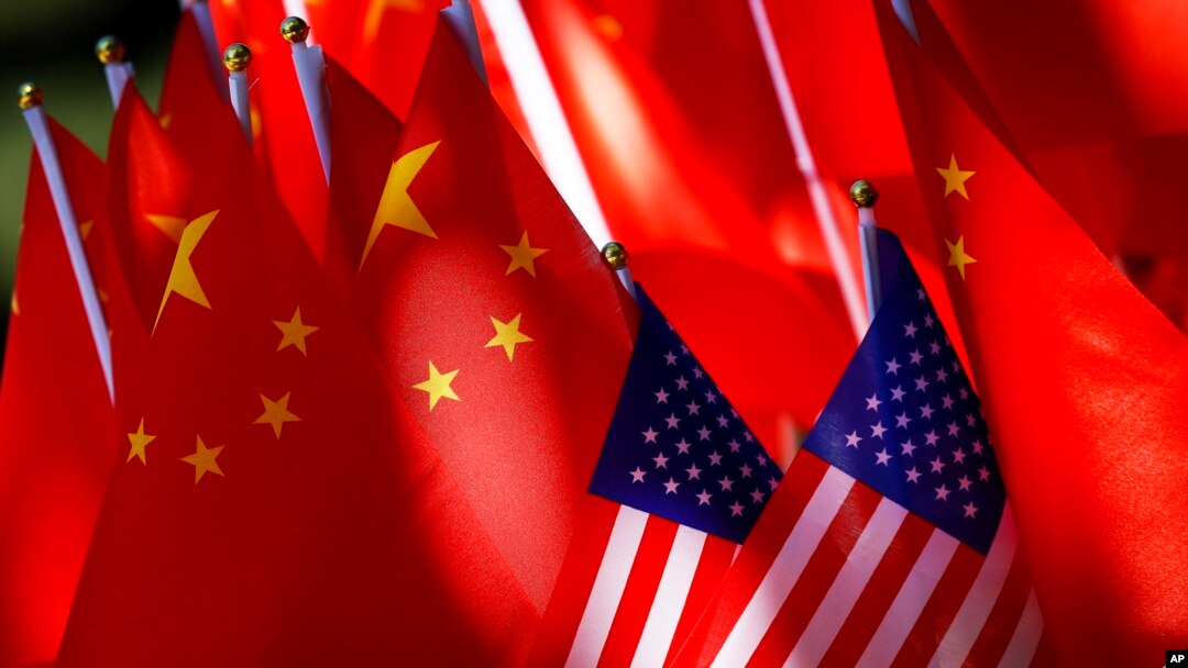 FILE - U.S. and Chinese flags are displayed together.