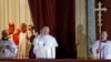 Pope Francis waves to the crowd from the central balcony of St. Peter's Basilica at the Vatican, March 13, 2013. 