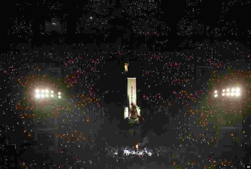 Thousands of people attend a candlelight vigil for victims of the Chinese government's brutal military crackdown nearly three decades ago on protesters in Beijing's Tiananmen Square, at Victoria Park in Hong Kong.