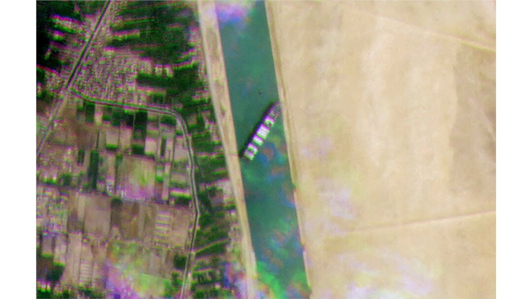 A satellite handout image released by Planet Labs Inc on March 24, 2021, shows the Taiwan-owned MV 'Ever Given' (Evergreen) container ship, a 400-metre- (1,300-foot-)long and 59-metre wide vessel, lodged sideways