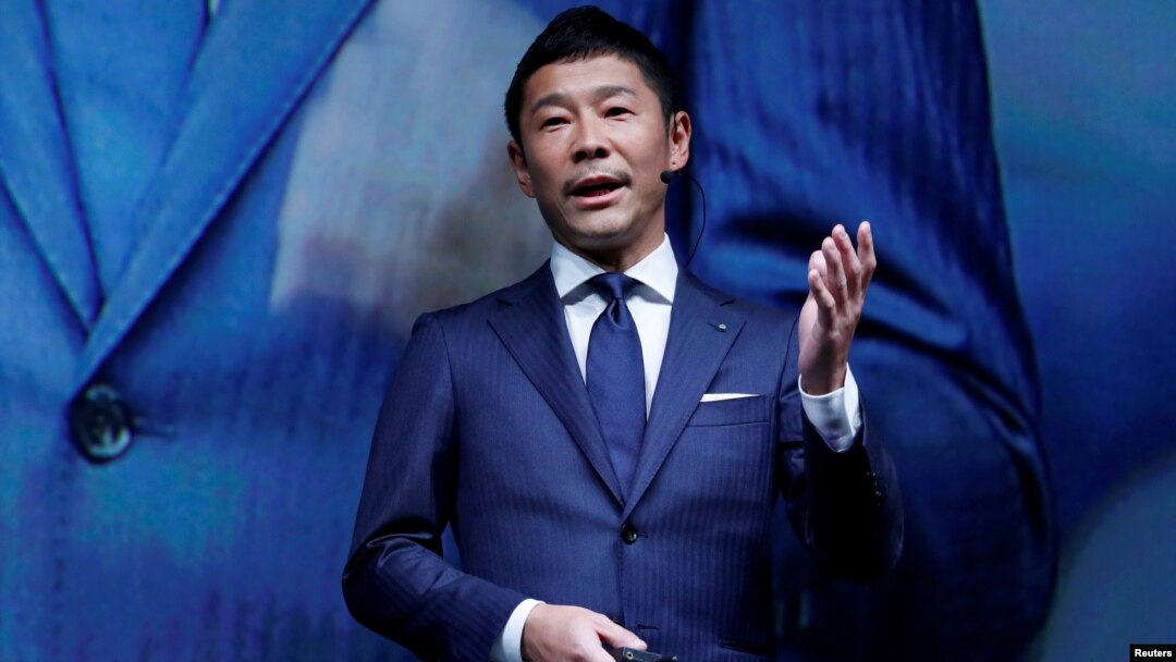 FILE - Yusaku Maezawa, the chief executive of Zozo, which operates Japan's popular fashion shopping site Zozotown and is officially called Start Today Co, speaks at an event launching the debut of its formal apparel items, in Tokyo, Japan, July 3, 2018.