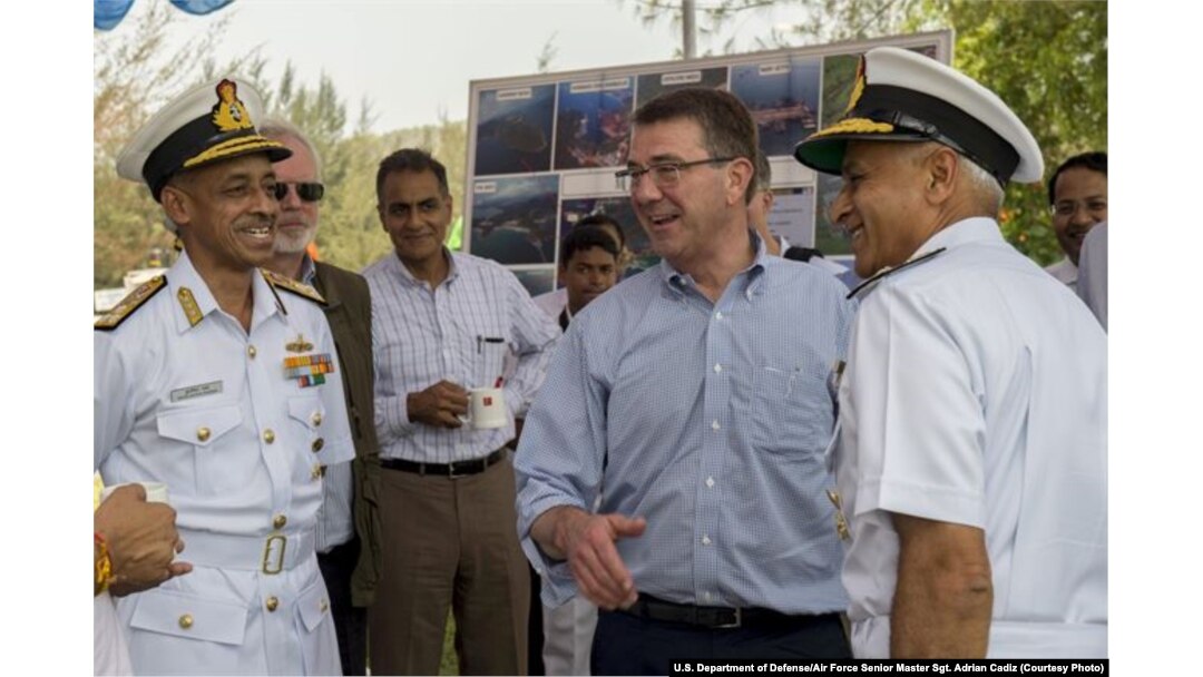 U.S. Defense Secretary Ash Carter, center right, laughs with Indian naval officers as he arrives at the Karwar naval base in India to visit the Indian aircraft carrier INS Vikramaditya, April 11, 2016.