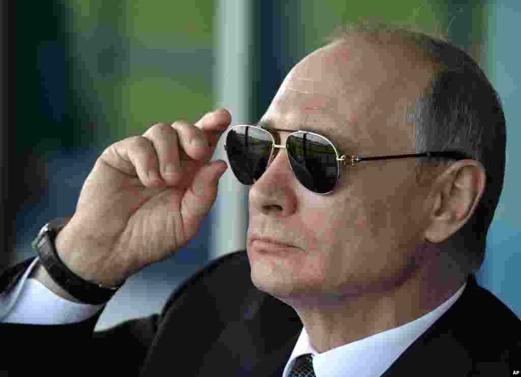 Russian President Vladimir Putin watches an aerobatics team performance at the opening ceremony of the MAKS-2017 in Zhukovsky, outside Moscow, Russia.