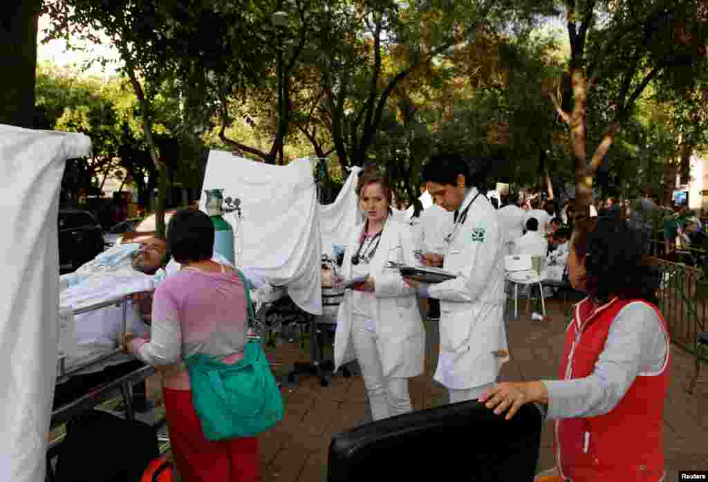 People are being treated for injuries after an earthquake hit Mexico City, Sept. 19, 2017.
