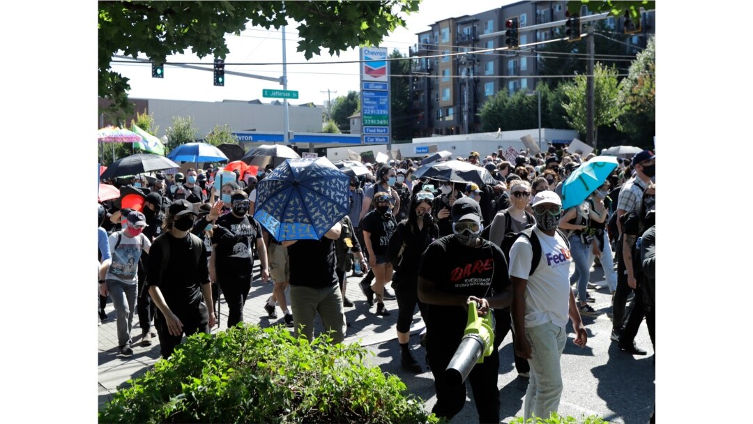 Protesters march near the King County Juvenile Detention Center, July 25, 2020, in Seattle in support of Black Lives Matter and against police brutality and racial injustice.