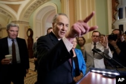 Senate Minority Leader Chuck Schumer of New York, joined by Sen. Sheldon Whitehouse, D-R.I., and Sen. Mazie Hirono, D-Hawaii, speaks to reporters on Capitol Hill in Washington about the struggle to move Supreme Court nominee Neil Gorsuch toward a final up-or-down vote on the Senate floor, April 4, 2017.