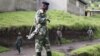 A M23 rebel fighter stands guard as they prepare for withdrawal from Karuba, some 62 kilometers west of Goma, DRC, November 28, 2012. 