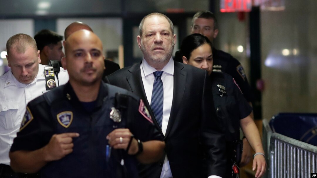 FILE - Harvey Weinstein, center, enters State Supreme Court in New York, Oct. 11, 2018.
