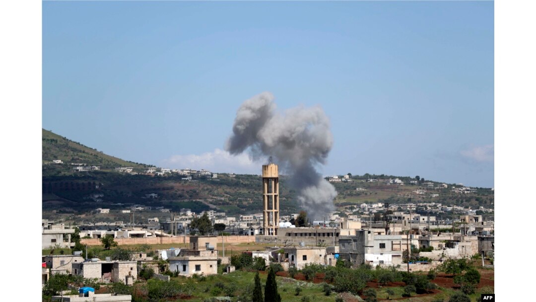 FILE - Smoke billows following bombardment by regime forces on the village of Basamis, Idlib province, Syria, May 4, 2019.