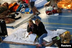 People rest following an earthquake in Amatrice, central Italy, Aug. 25, 2016.