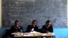 Children work on their teacher's table inside a classroom as a nationwide strike, by Kenyan teachers demanding a salary increase, left most of the country's learning institutions paralyzed in Nairobi, June 25, 2013. 