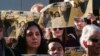 Holding signs that read "Protect Immigrants," pro-immigration demonstrators stand on the steps of the Kenneth Hahn Hall of Administration in downtown Los Angeles, California, Dec. 20, 2016.