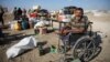 Displaced Palestinians make their way as they flee Hamad City following an Israeli evacuation order, in Khan Younis in the southern Gaza Strip, Aug. 16, 2024.