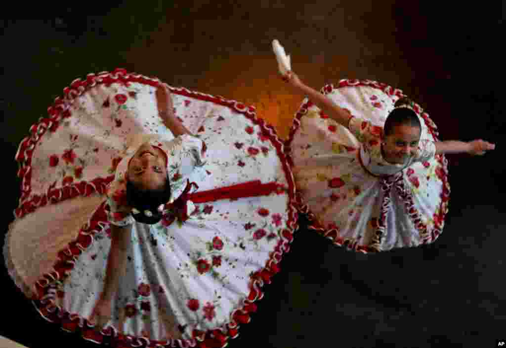 Transgender girls Josefa, 13, left, and Selenna, 8, twirl in traditional Chilean dance costumes before an event marking Transgender Children Day in Santiago, Chile.