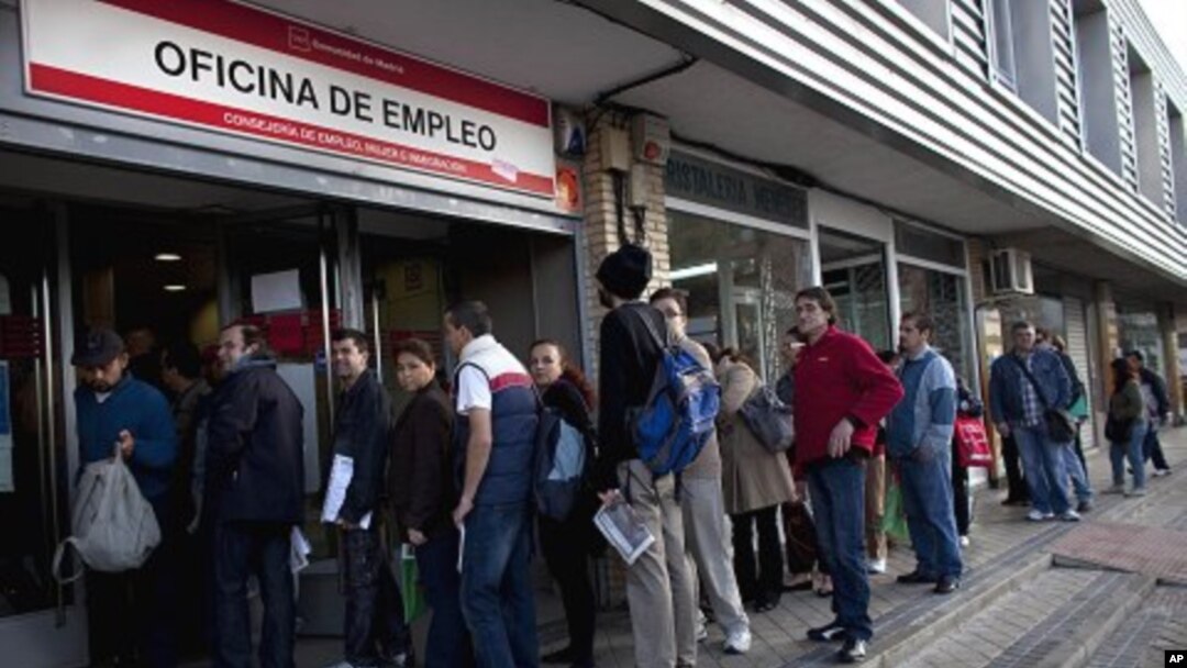 People line up to enter a government employment benefit office in Madrid on Monday, April 4, 2011