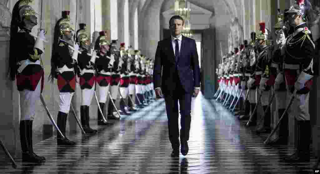 French President Emmanuel Macron walks through the Galerie des Bustes (Busts Gallery) to access the Versailles Palace's hemicycle where both houses of parliament (National Assembly and Senate) are gathered in the palace of Versailles, outside Paris. Macron laid out his political, security and diplomatic priorities at an extraordinary joint session of parliament at the chateau of Versailles.