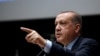 Turkey's President Recep Tayyip Erdogan, gestures as he delivers a speech during a ceremony to rejoin the ruling Justice and Development Party, or AKP, in Ankara, Turkey, May 2, 2017. 