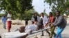 Residents transport a man wounded in crossfire during fighting between Somali government forces, backed by African Union troops, and Islamist militants in Madina District of Somalia's capital Mogadishu, Aug. 15, 2014. 