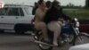 This image taken from video posted on Iranian investigative journalist Masih Alinejad’s Facebook page shows two Iranian women riding a motorcycle. 