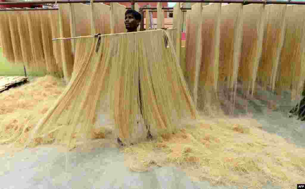 A worker dries thin vermicelli — which is used to make sheerkhorma, a traditional sweet dish prepared during the month of Ramadan — in Chennai, India.