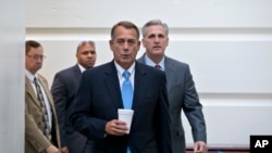 FILE - Speaker of the House John Boehner, R-Ohio, with House Majority Whip Kevin McCarthy, R-Calif., right, walks to a meeting of House Republicans at the Capitol in Washington.