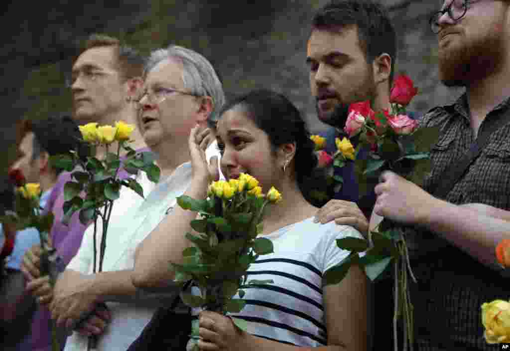 People take part in a vigil at Finsbury Park in north London, where a vehicle struck pedestrians near a mosque early Monday morning.