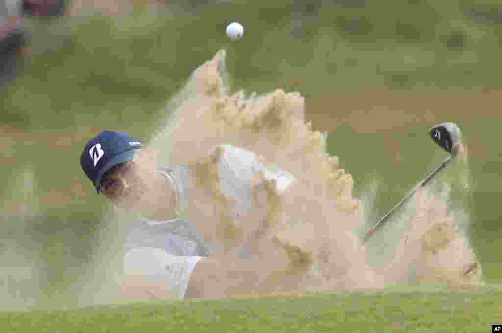 Matt Kuchar of the United States plays out of a bunker on the 4th hole during the final round of the British Open Golf Championship, at Royal Birkdale, Southport, England.