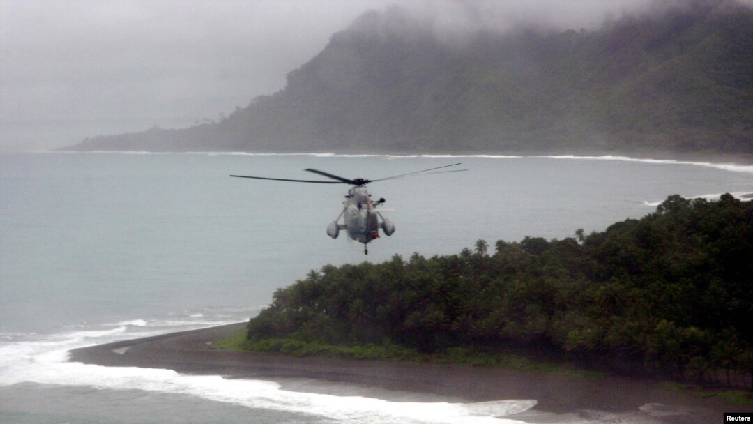 FILE - Australian helicopter flies low across the Weathercoast of the Solomon Islands.