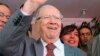 Beji Caid Essebsi (C), Nidaa Tounes party leader, gestures outside Nidaa Tounes headquarters in Tunis, October 28, 2014.