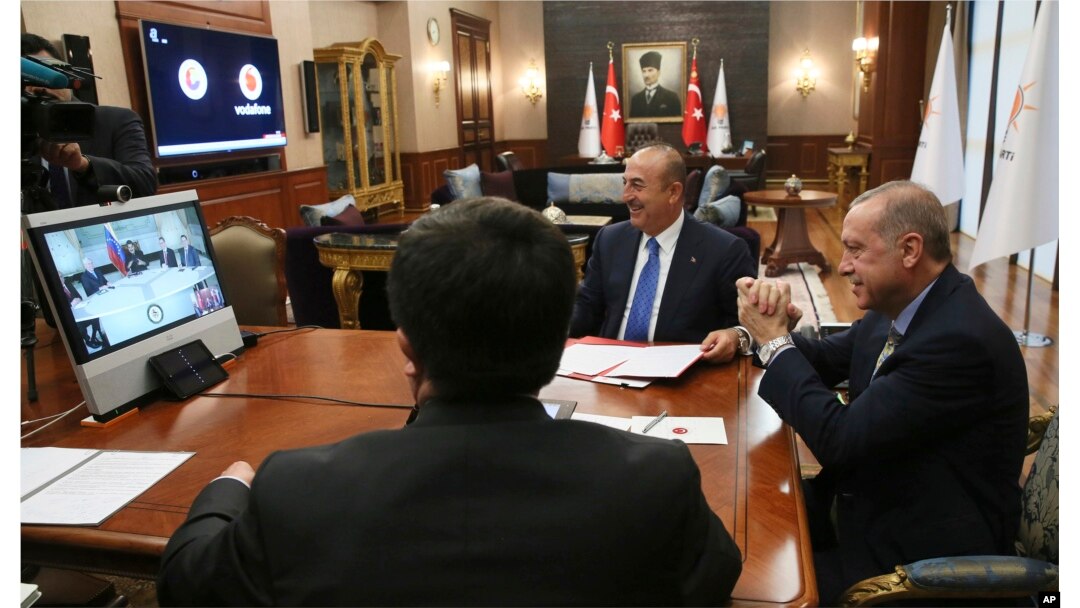 Turkey's President Recep Tayyip Erdogan, right, gestures as he speaks to Venezuela's President Nicolas Maduro during a conference call, in Ankara, Turkey, May 17, 2018.