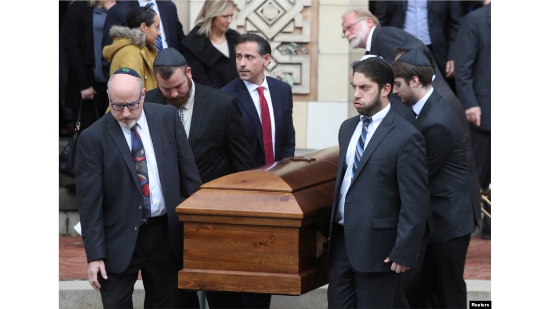 A casket is carried from Rodef Shalom Temple after funeral services for brothers Cecil and David Rosenthal, victims of the Tree of Life Synagogue shooting, in Pittsburgh, Pennsylvania, Oct. 30, 2018.