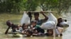 A Rohingya family reaches the Bangladesh border after crossing a creek of the Naf river on the border with Myanmmar, in Cox's Bazar's Teknaf area, Sept. 5, 2017.