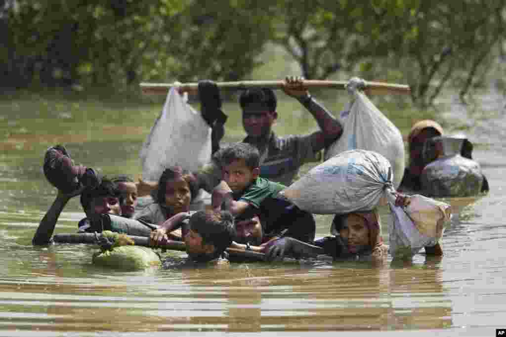 A Rohingya family reaches the Bangladesh border after crossing a creek of the Naf river on the border with Myanmmar, in Cox's Bazar's Teknaf area.