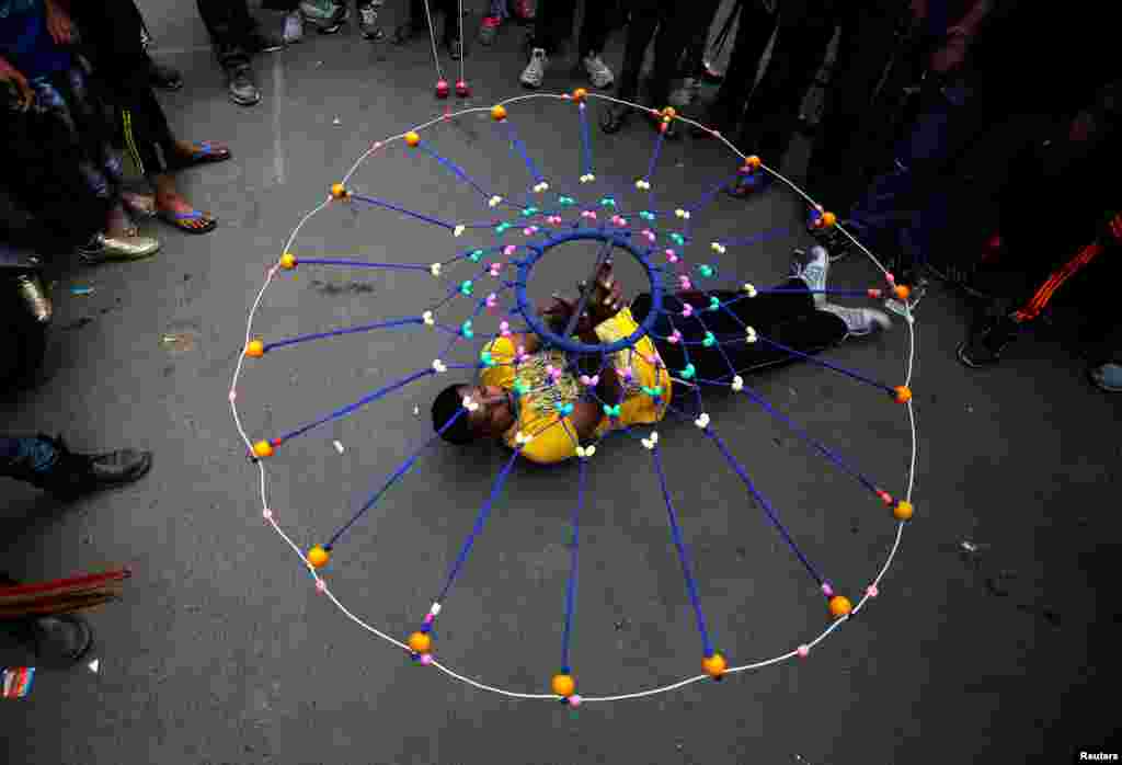 A Hindu devotee performs Gatka, a traditional martial arts form, during a rehearsal for the annual Rath Yatra, or chariot procession, which commemorates a journey by Hindu god Jagannath, his brother Balabhadra, and sister Subhadra, in specially made chariots, in Ahmedabad, India.