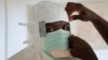 FILE - A nurse gears up to enter a high-risk zone of an Ebola treatment unit run by Doctors Without Borders / Medecins Sans Frontieres in Monrovia, Liberia.