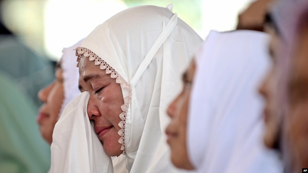 A woman weeps during a prayer marking 20 years of the massive Indian Ocean tsunami, in Banda Aceh, Indonesia, Dec. 26, 2024.